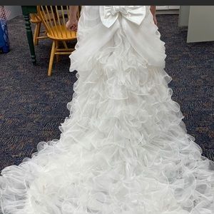 White ruffled wedding dress .